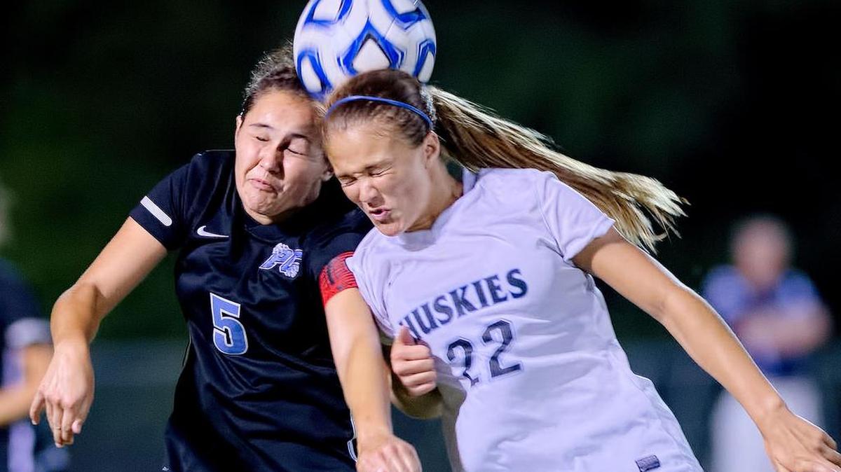 
Panther Creek's Rachael Everhart (5) and Hough's Ashley Johnson (22) go for a header during 2014 the NCHSAA 4A Women's Championship Soccer Game in Raleigh, N.C. Hough won the game, 1-0 (OT). 

