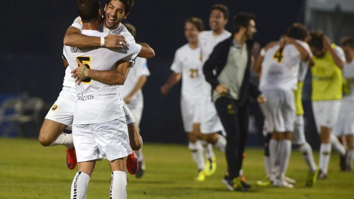 The Pfeiffer Falcons' Jaime Siaj gives teammate Dani Siaj a hug as the team celebrates after beating Cal Poly Pomona 4-0 for the 2015 NCAA Division II soccer title.