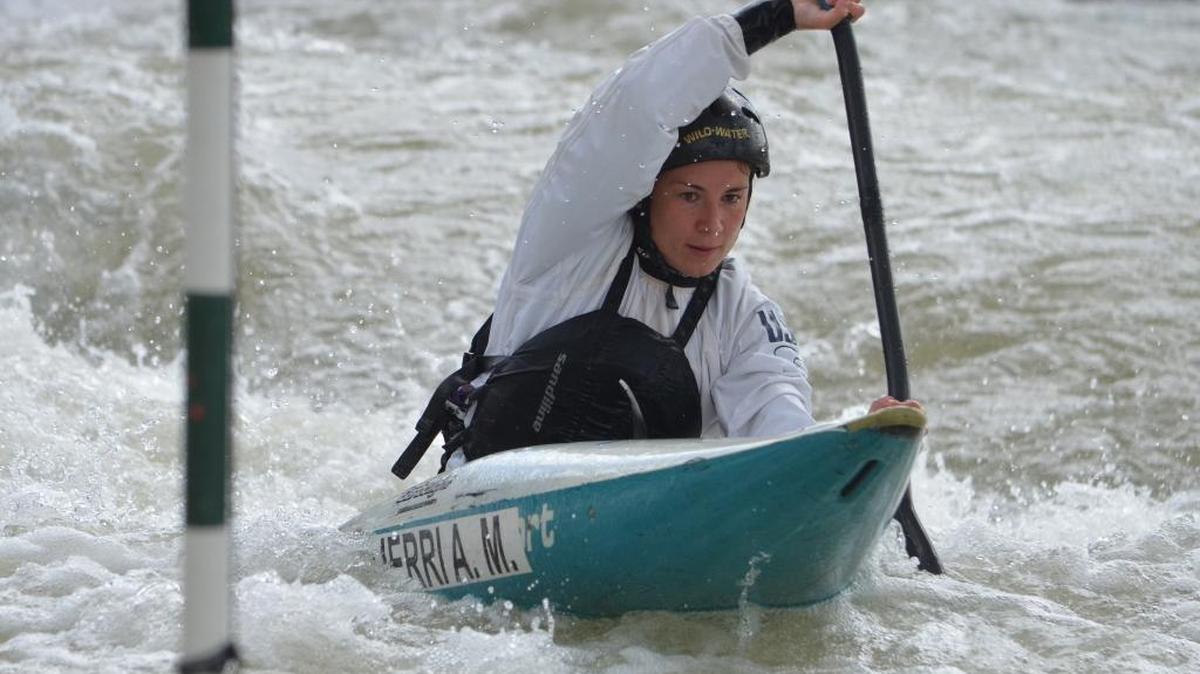 Kayaker Anna Maria Ifarraguerri of Belmont digs past a hanging gate during a practice run Thursday at the U.S. Olympic canoe-kayak slalom-racing trials at the U.S. National Whitewater Center.