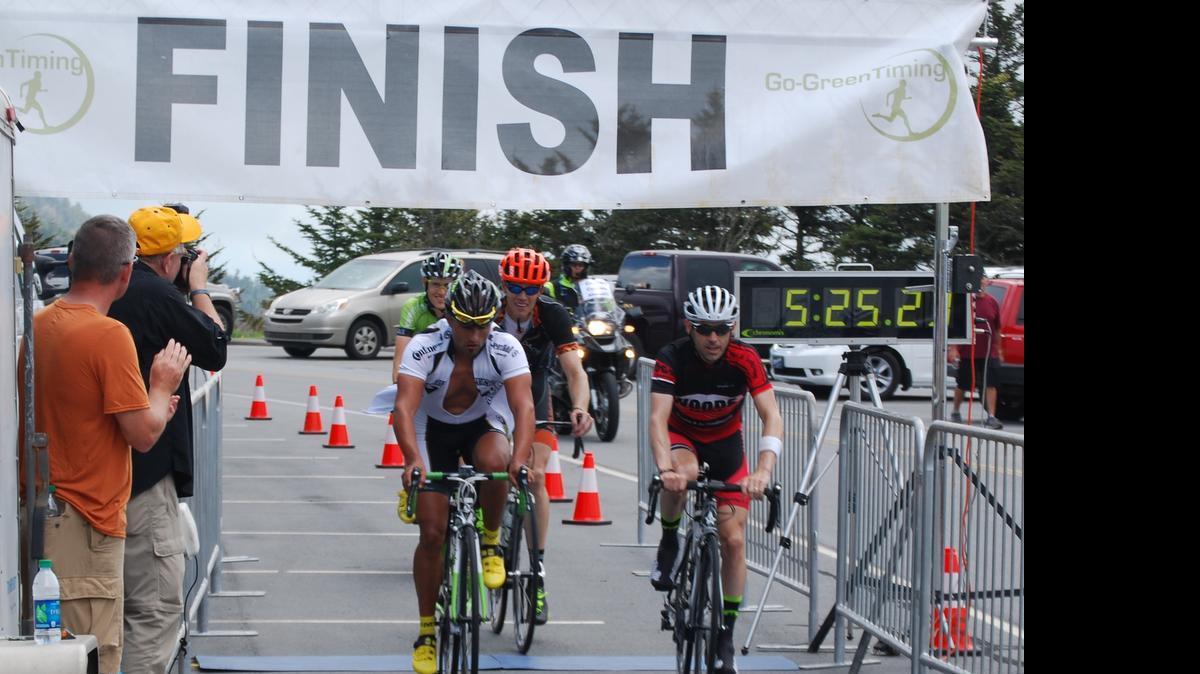 
Mathias Nothegger of Charlotte (left) rides across the finish line with Scottie Weiss of Radford, Va., for the fastest time in the 40th annual Assault on Mount Mitchell bicycle ride. Their time was 5 hours, 25 minutes, 22 seconds. Nothegger, Weiss, John Overton of Wilmington and Bradford Perley of Brevard agreed to finish together. Sixth- and eighth-fastest were Charlotteans Peter Jasmoch and Armin Pfaff. The 103.1-mile ride began in Spartanburg, S.C., and ended near the summit of 6,684-foot-high Mount Mitchell.
