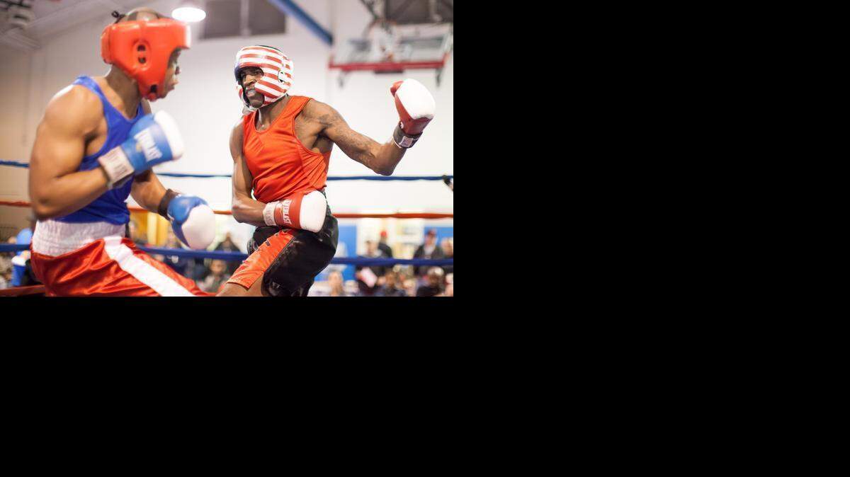 
Dazme Woods, right, of Charlotte takes a swing at Kennan Nesbitt of Tryon during the N.C. Golden Gloves boxing tournament on Friday, March 6, 2015 at the Sugaw Creek Recreation Center in Charlotte.
