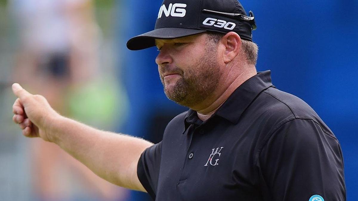 
Jason Gore waves to the gallery after making his birdie putt on the 18th green during the third round of the Wyndham Championship at Sedgefield Country Club on Saturday in Greensboro.
