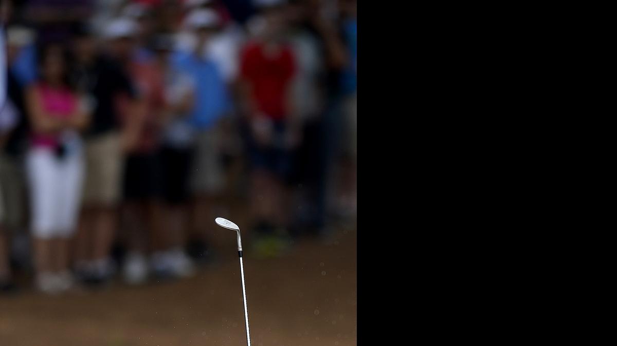 
Webb Simpson hits a shot from a sand bunker along the fourth green during the Wells Fargo Championship on Sunday, May 17, 2015 at Quail Hollow Club.
