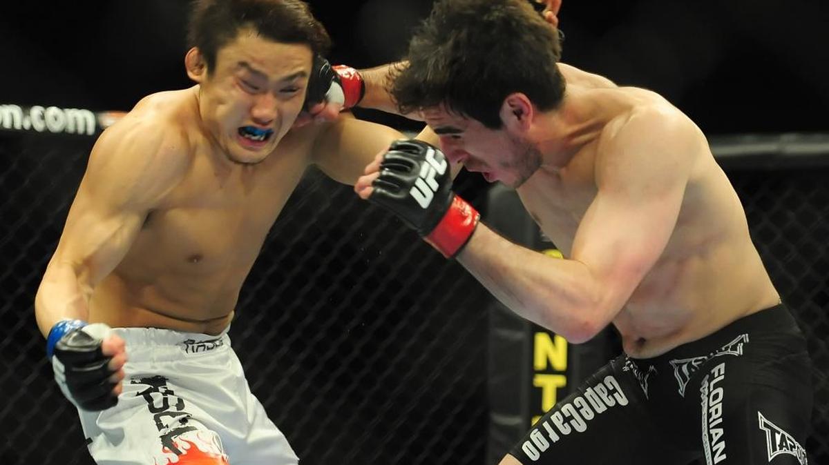 Kenny Florian connects with a right punch to the right side of Takanori Gomi’s face during their UFC Fight Night bout on March 31, 2010, at Bojangles’ Coliseum.