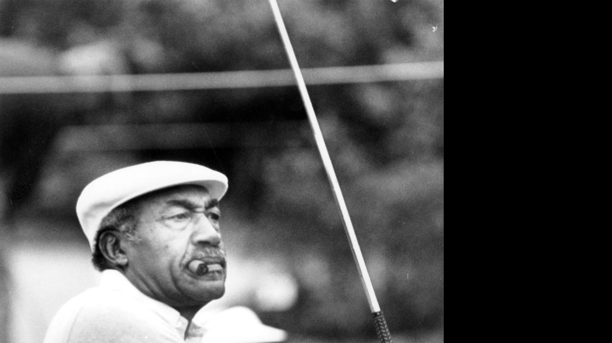 
Charles Sifford plays during the Johnny Mathis Senior golf tournament in Los Angeles in March 1986. Authorities say the son and ex-daughter-in-law of the late black golfing pioneer Sifford have been indicted on charges related to the theft of more than $1 million from him. Sifford, born in Charlotte, died Feb. 3 at 92.
