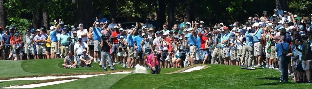 Tiger Woods’ fans followed him in great numbers from the first tee to the final hole at Quail Hollow Club for Thursday’s first round of the 2018 Wells Fargo Championship at Quail Hollow Club. Above, Woods is the center of attention as he hits from a sand trap along the seventh fairway.