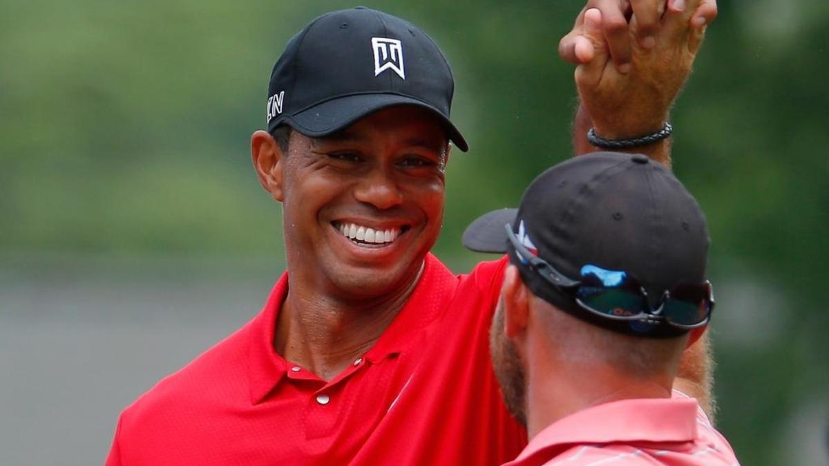 
Scott Brown is congratulated by Tiger Woods, left, after Brown scored a hole-in-one on the third hole during Sunday’s final round of the Wyndham Championship at Sedgefield Country Club in Greensboro.
