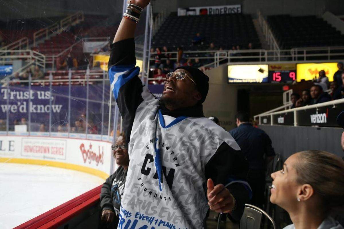 Cam Newton attended a Charlotte Checkers game Thursday night and showed a lot of team spirit.