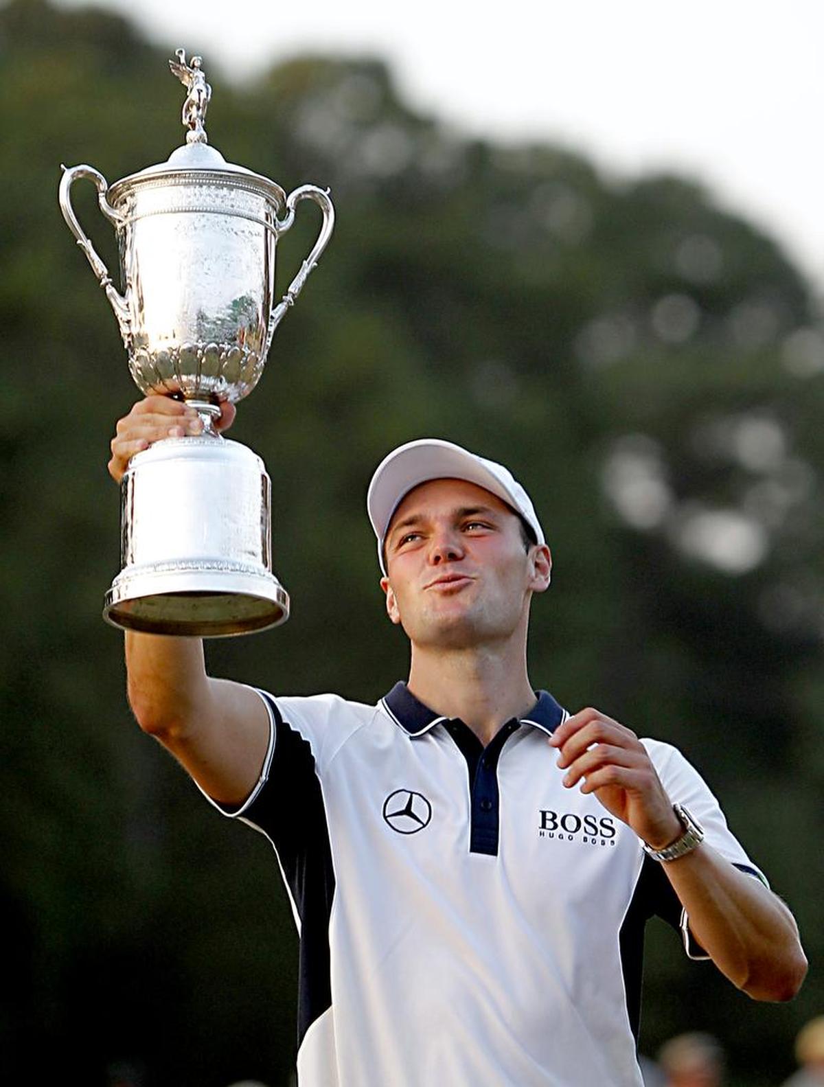 Martin Kaymer hoists the trophy after he won the U.S. Open at Pinehurst No. 2 on Sunday, June 15, 2014. He was 9 under for the tournament. He is from Germany.