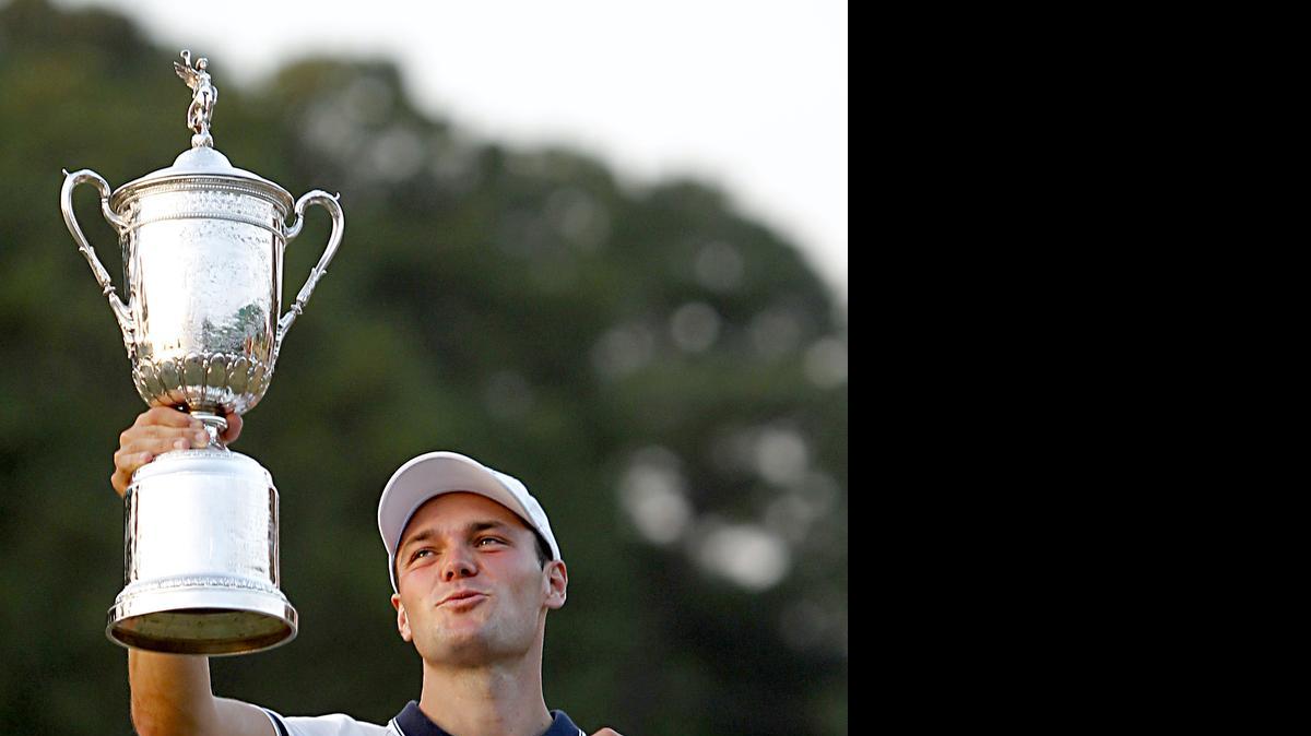 Martin Kaymer hoists the trophy after he won the U.S. Open at Pinehurst No. 2 on Sunday, June 15, 2014. He was 9 under for the tournament. He is from Germany.