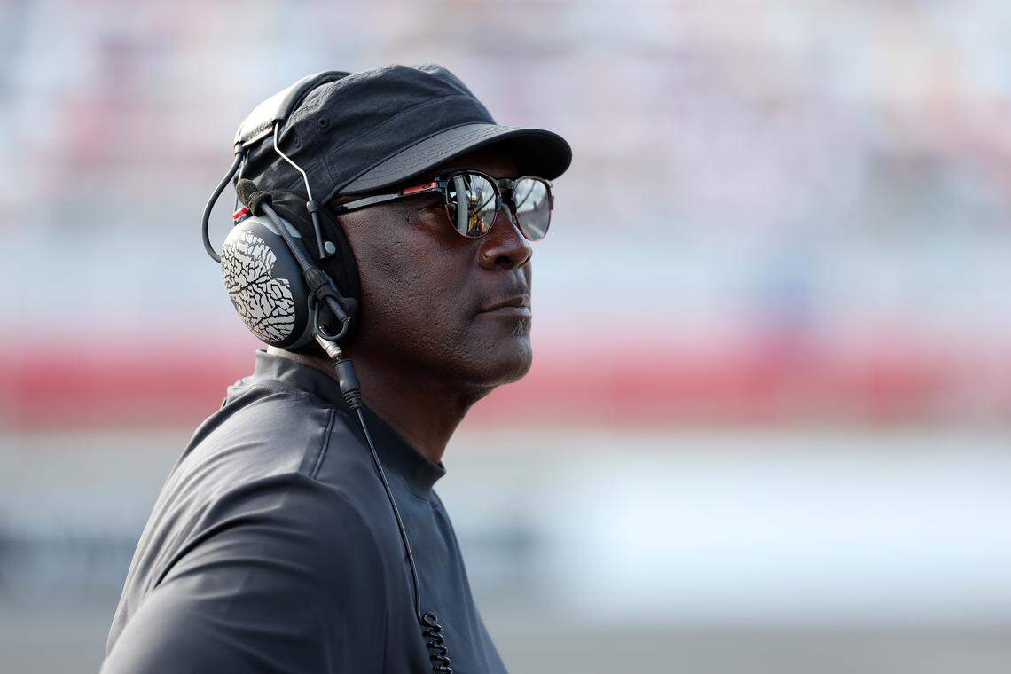 Michael Jordan, NBA Hall of Famer and co-owner of 23XI Racing, listens to the race on pit road during the NASCAR Cup Series Bank of America ROVAL 400 on Oct. 5, 2025, at Charlotte Motor Speedway.