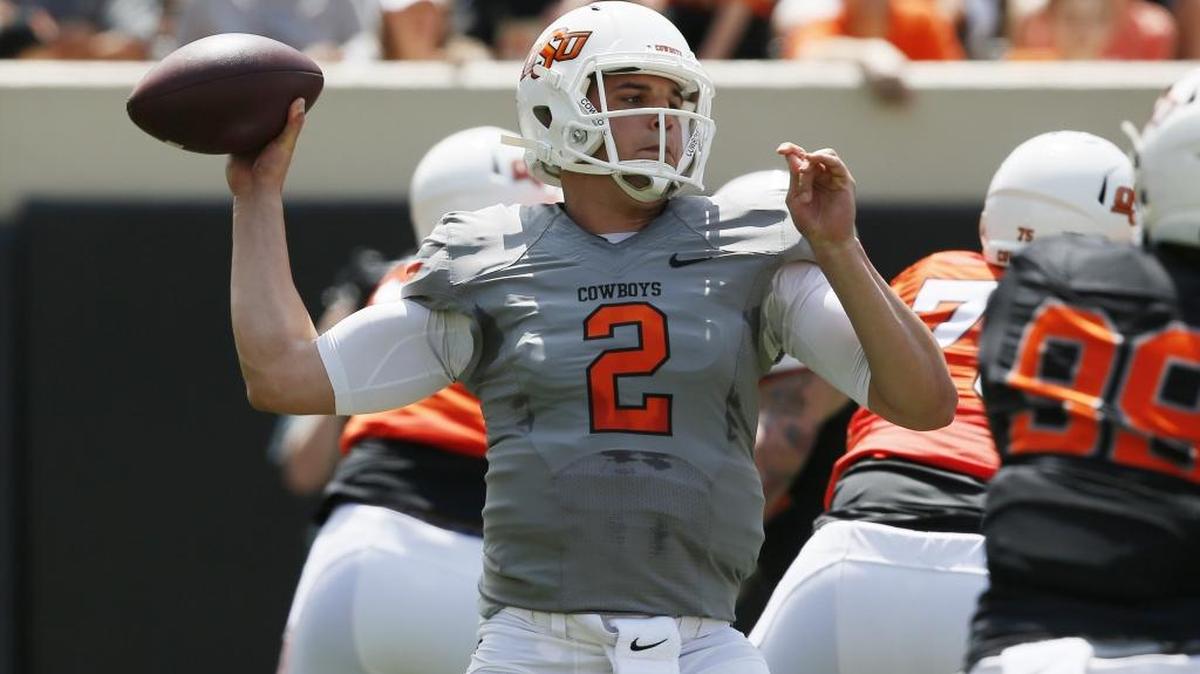 FILE - In this Saturday, April 15, 2017 file photo, Oklahoma State quarterback Mason Rudolph throws during an intra squad spring NCAA college football game in Stillwater, Okla. Oklahoma State believes Rudolph has a shot at the Heisman Trophy. (AP Photo/Sue Ogrocki)