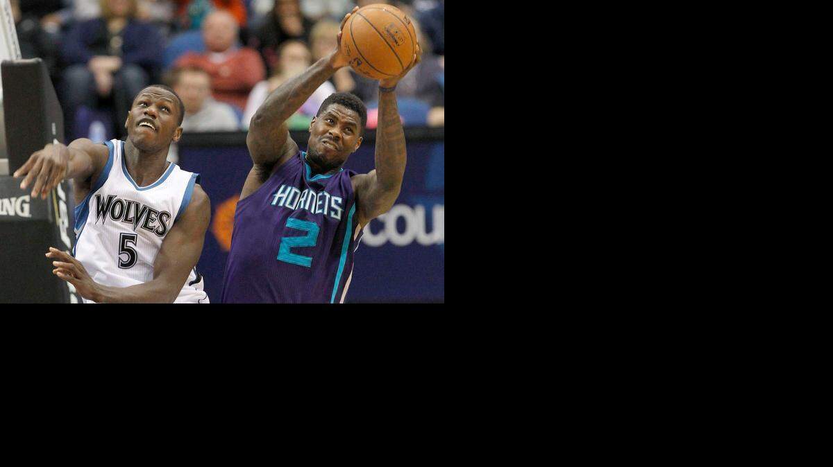
Charlotte Hornets forward Marvin Williams (2) pulls down a rebound over Minnesota Timberwolves center Gorgui Dieng (5), of Senegal, during the first half of an NBA basketball game in Minneapolis, Sunday, March 22, 2015.

