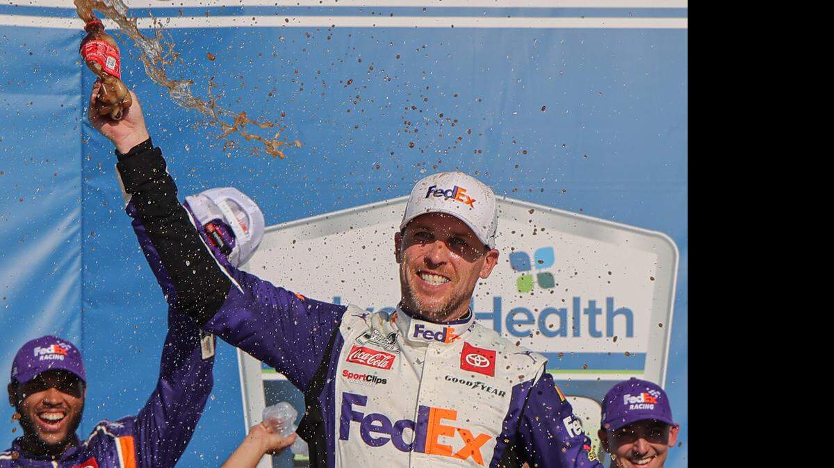Denny Hamlin, driver of the #11 FedEx Express Toyota, celebrates in victory lane after winning the NASCAR Cup Series Advent Health 400 at Kansas Speedway on Sunday, May 7, 2023, in Kansas City, Kansas. (Jonathan Bachman/Getty Images/TNS)