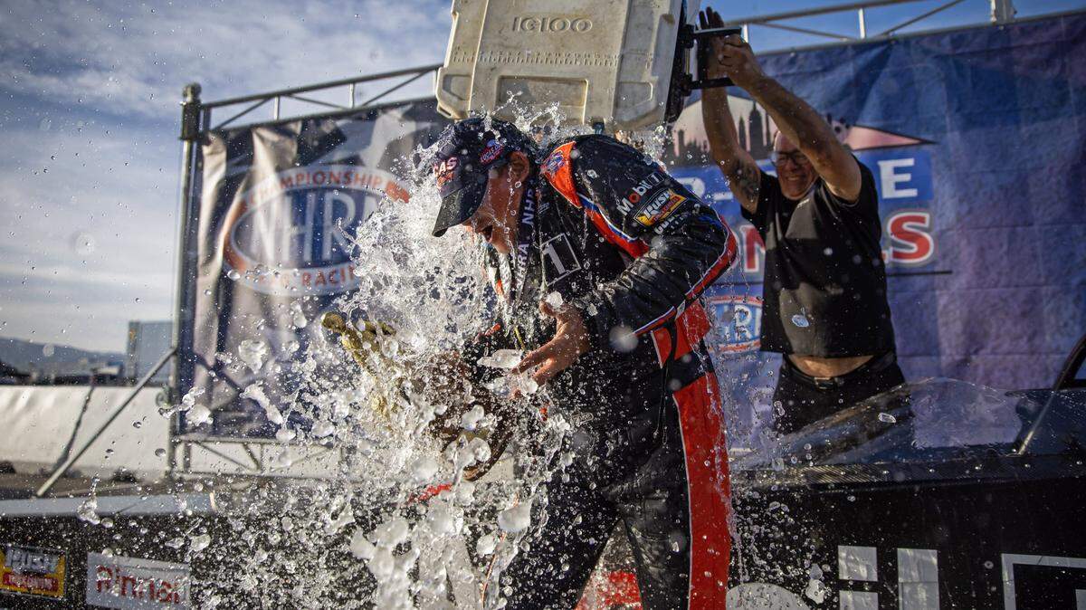 Apr 16, 2023; Las Vegas, NV, USA; NHRA top alcohol dragster driver Tony Stewart is dunked with a cooler of ice water as he celebrates after winning the Four Wide Nationals at The Strip at Las Vegas Motor Speedway. Mandatory Credit: Mark J. Rebilas-USA TODAY Sports