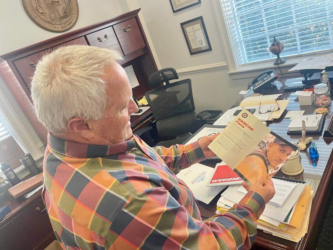 Monty Crump, the city manager of Rockingham, flips through a book entitled “Why NASCAR should keep racing at The Rock,” as part of a presentation to try to keep the NASCAR Cup Series at now-named Rockingham Speedway before the Cup Series left in 2004.