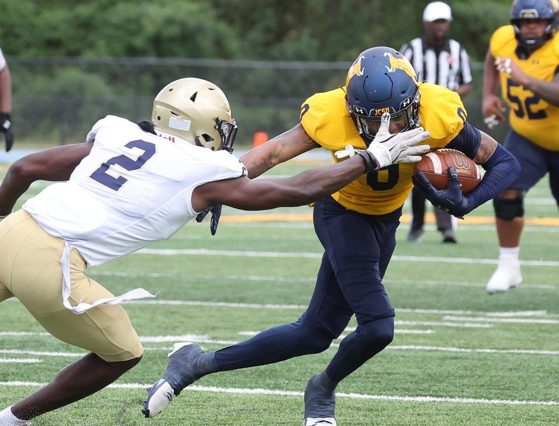 Johnson C. Smith University's Reginald Daniel carries the ball against Bluefield State University's Samuel Olokeogun Saturday, Sept. 27, 2025 at the Eddie C. McGirt Field in Charlotte.