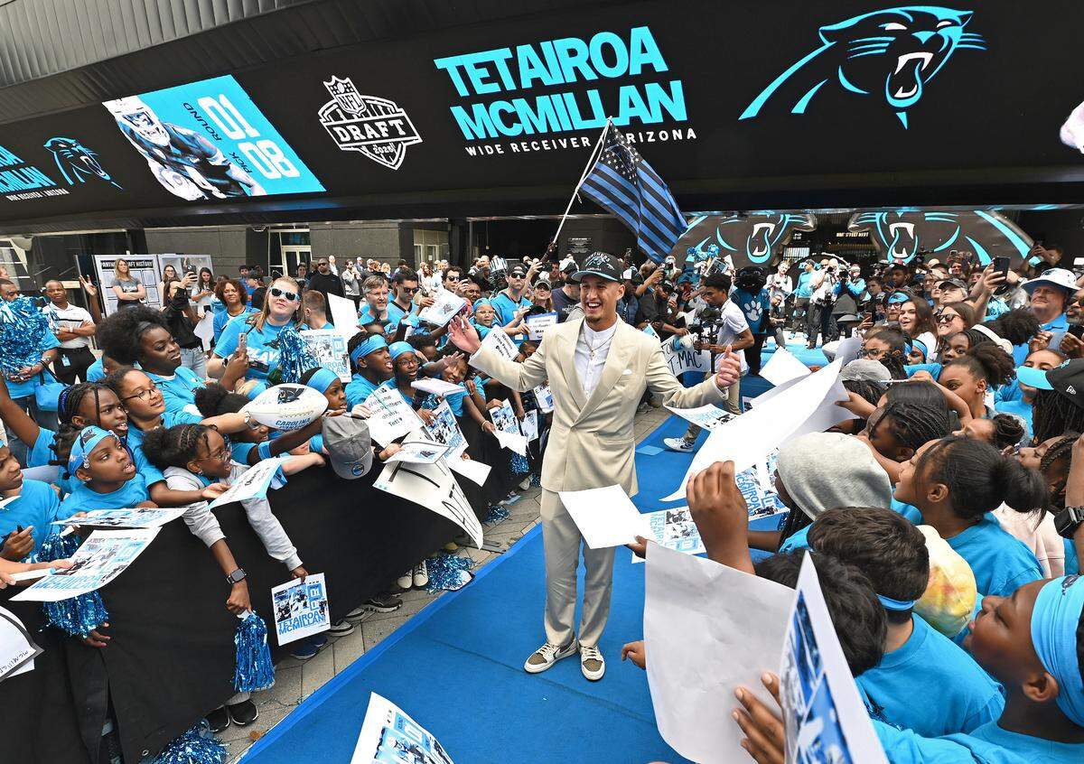 Carolina Panthers draft pick Tetairoa McMillan, center, stops and poses amongst the cheering fans upon arrival at Bank of America Stadium on Friday, April 25, 2025. The Panthers selected McMillan with the eighth pick in the 2025 NFL Draft.