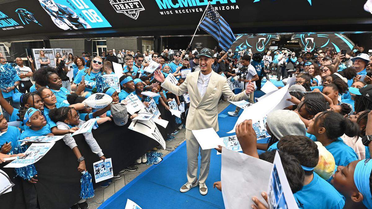 Carolina Panthers draft pick Tetairoa McMillan (center) stops and poses amongst the cheering fans at Bank of America Stadium on Friday, April 25, 2025. The Panthers selected McMillan with the eighth pick in the 2025 NFL Draft.