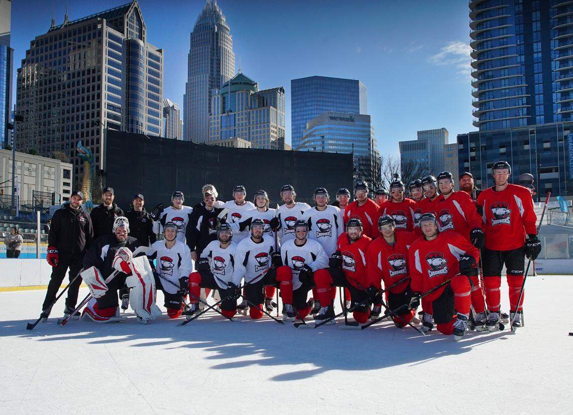 The Charlotte Checkers pose for a picture at Truist Field on Dec. 12, 2022 after the team’s first outdoor practice.