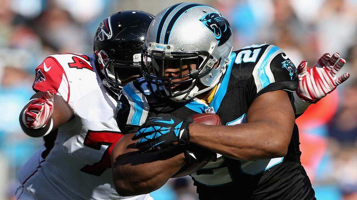  Jonathan Stewart #28 of the Carolina Panthers runs the ball against Joey Mbu #74 of the Atlanta Falcons in the 1st quarter during their game at Bank of America Stadium on December 13, 2015 in Charlotte, North Carolina. (Photo by Streeter Lecka/Getty Images)