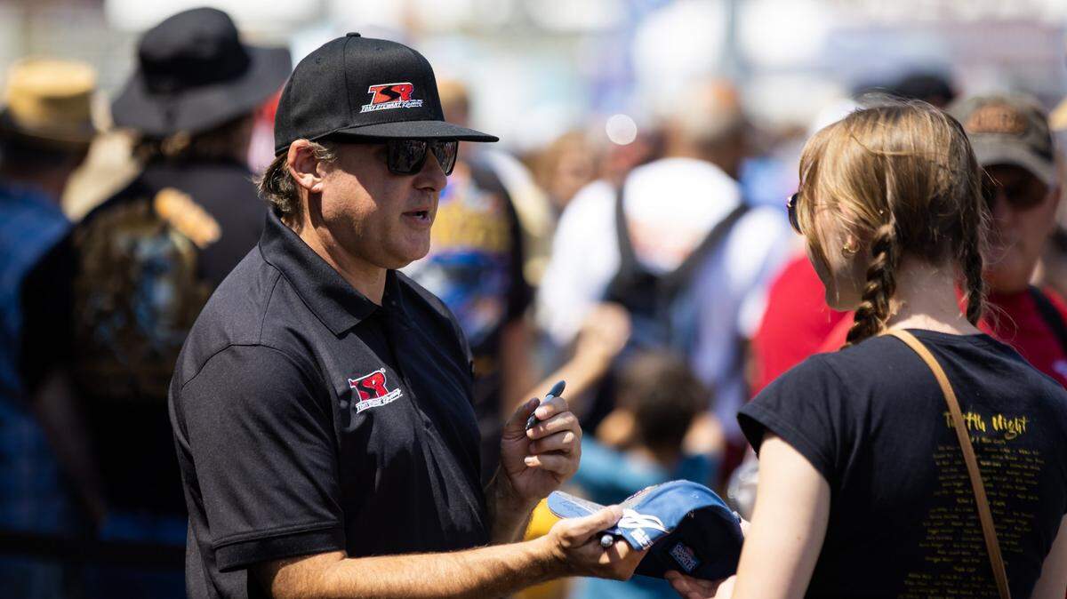 Jun 10, 2023; Bristol, TN, USA; NHRA team owner Tony Stewart signs autographs in the pits during qualifying for the Thunder Valley Nationals at Bristol Dragway. Mandatory Credit: Mark J. Rebilas-USA TODAY Sports