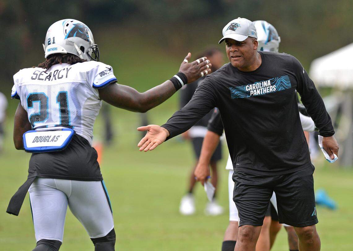 Carolina Panthers defensive coordinator Eric Washington, right, reaches out to congratulate safety Da'Norris Searcy, left, following a play during practice on Thursday, August 2, 2018 at Wofford College in Spartanburg, SC.