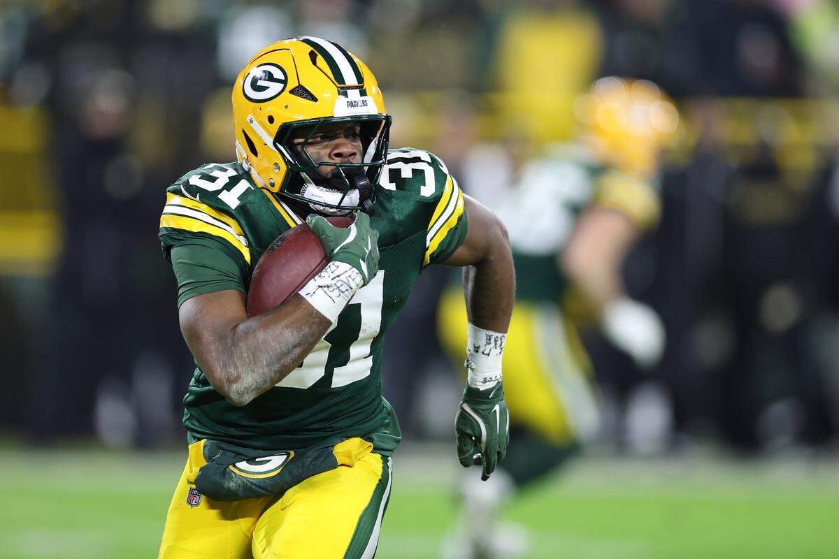 Emanuel Wilson of the Green Bay Packers runs for yards during a game against the New Orleans Saints at Lambeau Field on December 23, 2024 in Green Bay, Wisconsin. 