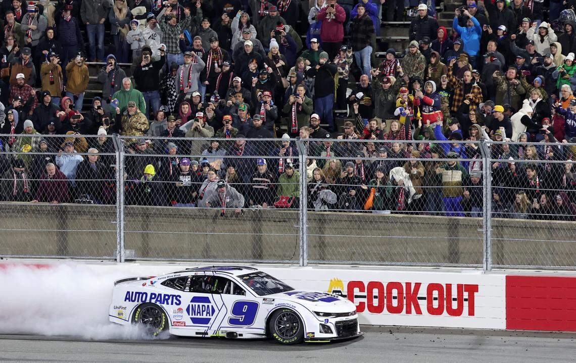 Fans look on as NASCAR Cup Series driver Chase Elliott does a burnout along the backstretch safety barrier while celebrating his winning the Cook Out Clash race on Feb. 2, 2025, at Bowman Gray Stadium in Winston-Salem.