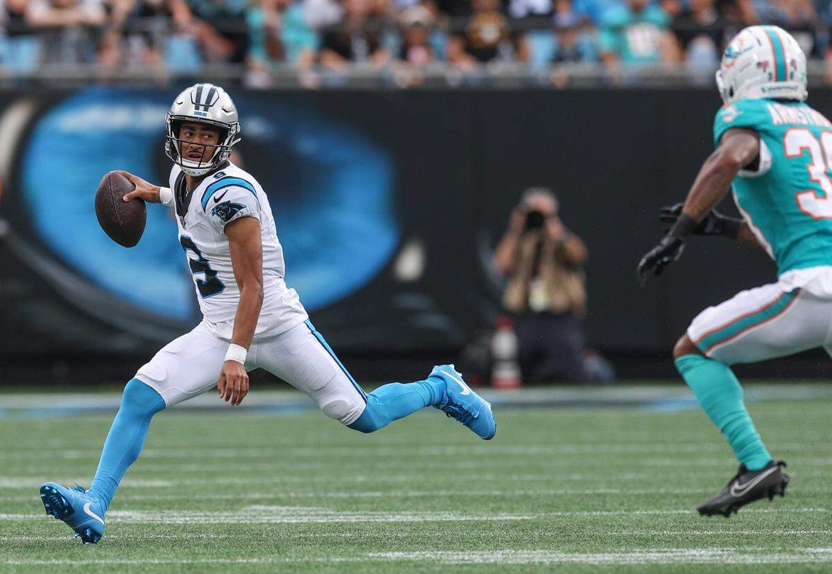 Panthers quarterback Bryce Young extends fully as he runs on a keeper as Dolphins cornerback Cornell Armstrong gives chase during the game at Bank of America Stadium in Charlotte, North Carolina, on Sunday, Oct. 5, 2025.