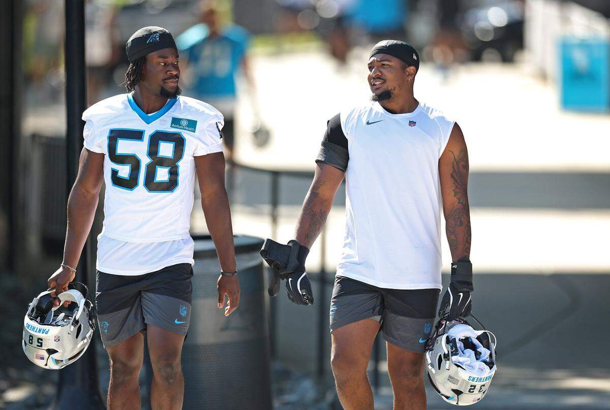 Carolina Panthers linebackers Maz Mwansa, left, and Trevin Wallace, right, walk to the team’s training camp practice on Wednesday, July 23, 2025.