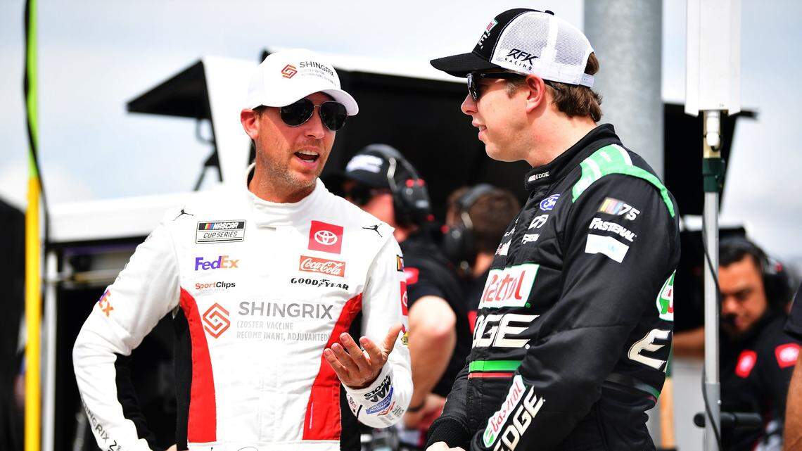Mar 11, 2023; Avondale, Arizona, USA; NASCAR Cup Series driver Denny Hamlin (11) speaks with driver Brad Keselowski (6) during qualifying for the United Rentals Work United 500 at Phoenix Raceway. Mandatory Credit: Gary A. Vasquez-USA TODAY Sports
