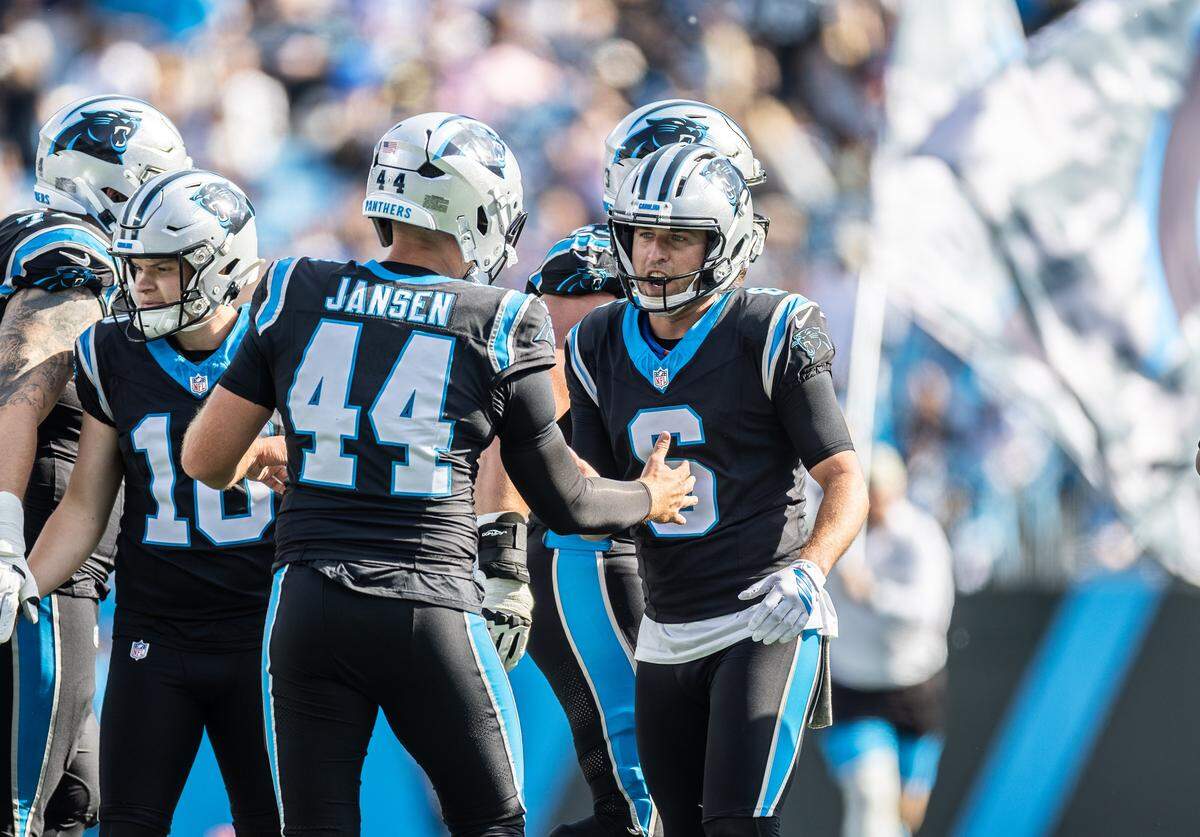 Carolina Panthers long snapper JJ Jansen, left, high-fives punter Sam Martin at Bank of America Stadium in Charlotte on Sunday, Nov. 9, 2025.