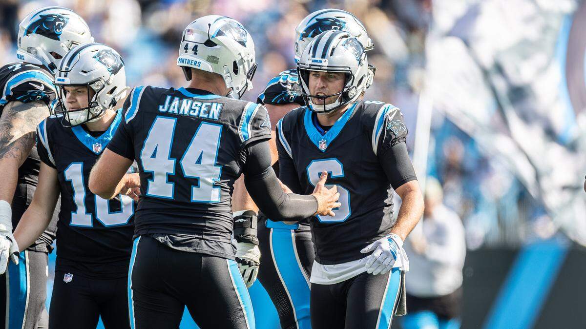 Carolina Panthers long snapper JJ Jansen, left, high fives Carolina Panthers punter Sam Martin on Nov. 9, 2025, at Bank of America Stadium in Charlotte.