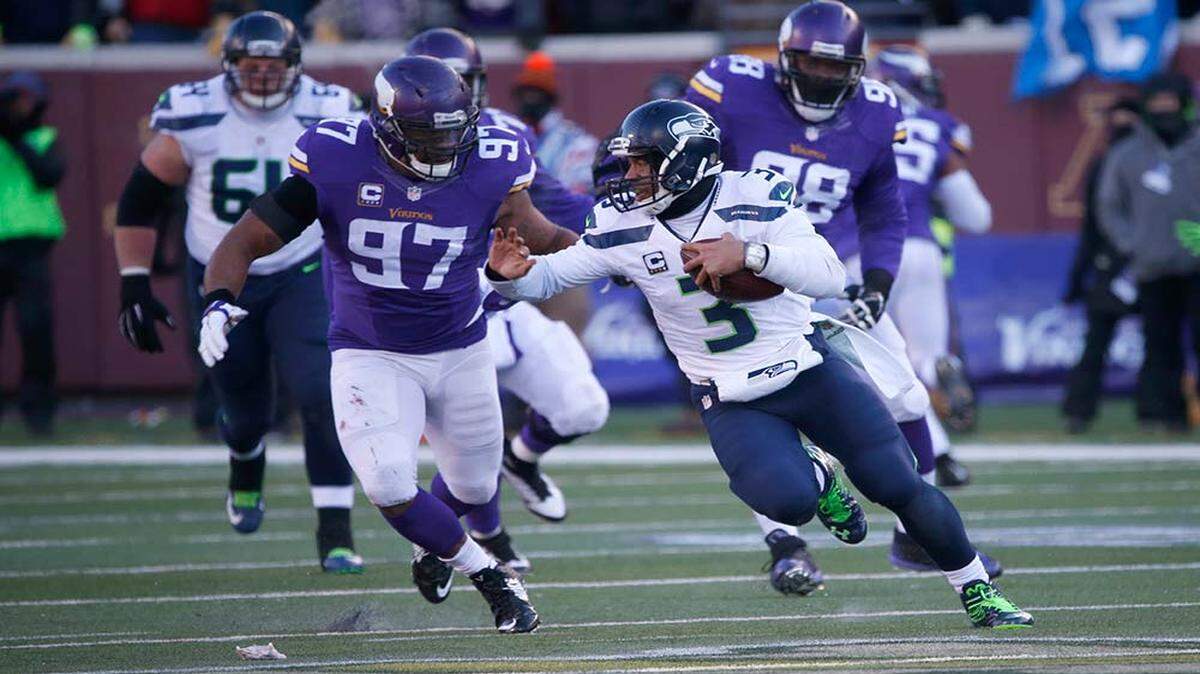 Seattle Seahawks quarterback Russell Wilson (3) runs past Minnesota Vikings offensive guard Michael Harris (79) during the second half of an NFL wild-card football game, Sunday, Jan. 10, 2016, in Minneapolis. (AP Photo/Jim Mone)