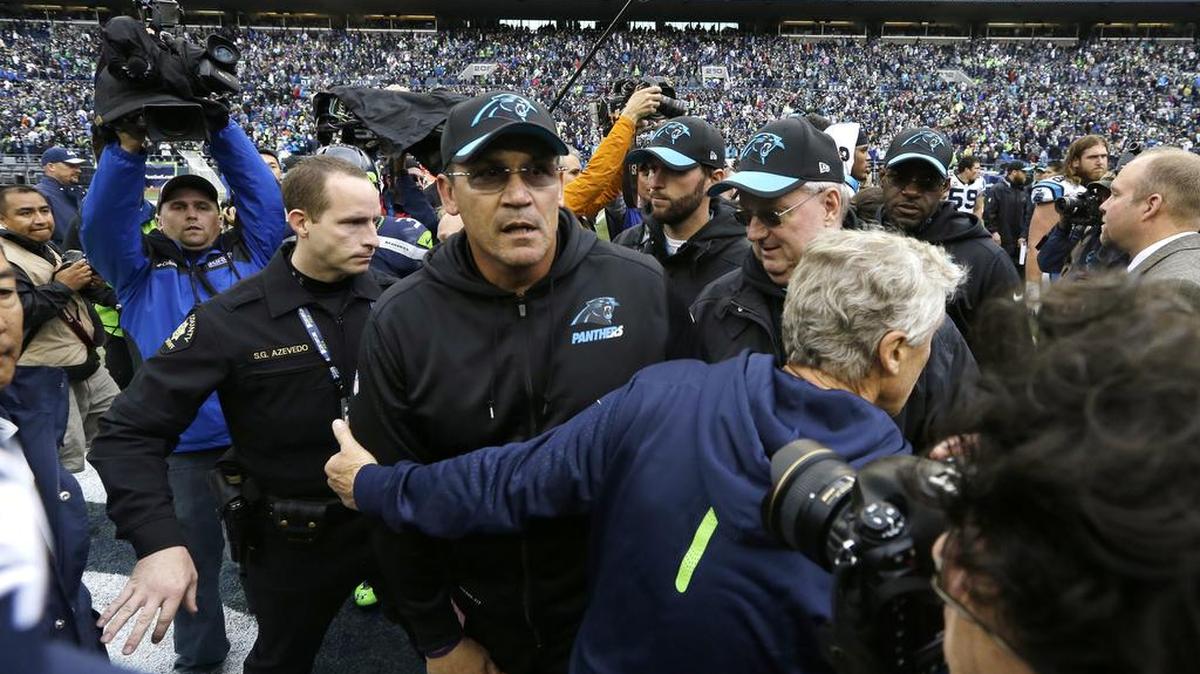 
Carolina Panthers head coach Ron Rivera, center, is greeted by Seattle Seahawks head coach Pete Carroll, right, following an NFL football game, Sunday in Seattle. The Panthers beat the Seahawks 27-23.

