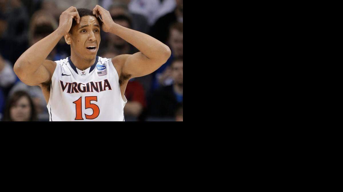 
Virginia's Malcolm Brogdon (15) reacts after being called for a foul against Michigan State during the second half of an NCAA tournament college basketball game in the Round of 32 in Charlotte, N.C., Sunday, March 22, 2015. 
