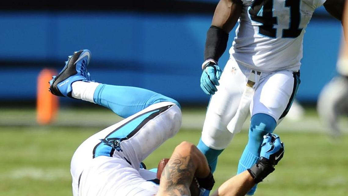 
Carolina Panthers' A.J. Klein (56) comes down with an interception against the Houston Texans, as Roman Harper (41) closes in, during the second half at Bank of America Stadium on Sunday. The Panthers won, 24-17.
