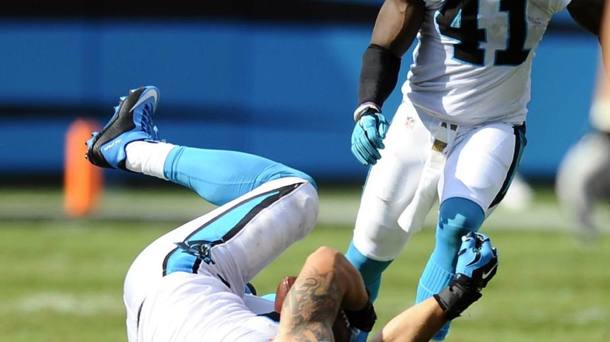 
Carolina Panthers' A.J. Klein (56) comes down with an interception against the Houston Texans, as Roman Harper (41) closes in, during the second half at Bank of America Stadium on Sunday. The Panthers won, 24-17.
