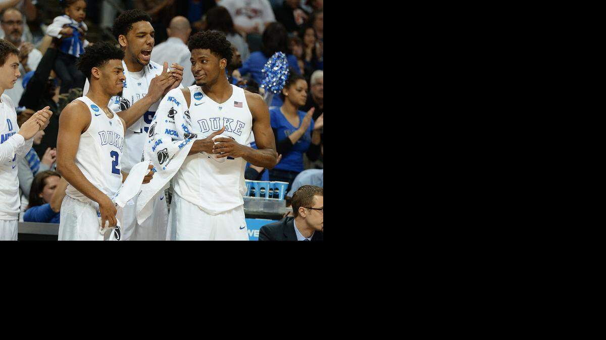 
Duke guard Quinn Cook (2), center Jahlil Okafor (15) and forward Justise Winslow (12) celebrate at game’s end as the Blue Devils defeated Robert Morris 85-56 at the Time Warner Cable Arena in Charlotte. Friday, March 20, 2015. The three provided 49 of the Blue Devils' points.
