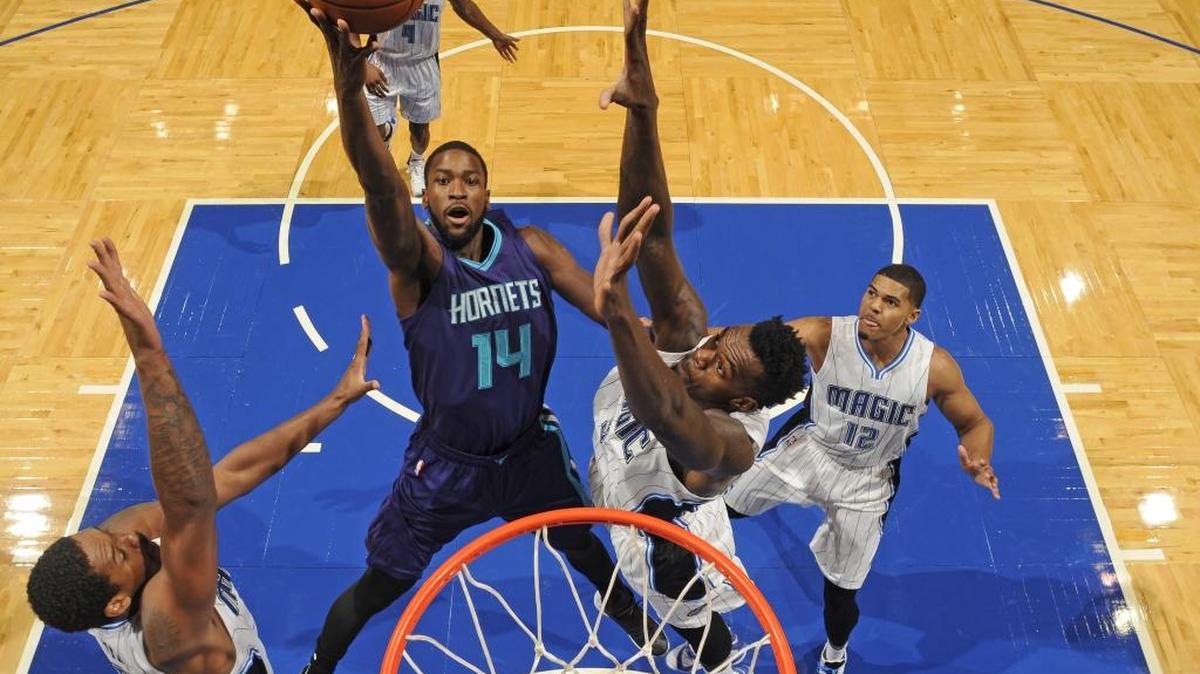 
Michael Kidd-Gilchrist (14) of the Charlotte Hornets drives against the Orlando Magic during a preseason game on Saturday at Amway Center in Orlando. Later, Kidd-Gilchrist injured his shoulder, and Monday he was diagnosed with a labrum tear that could end his season.
