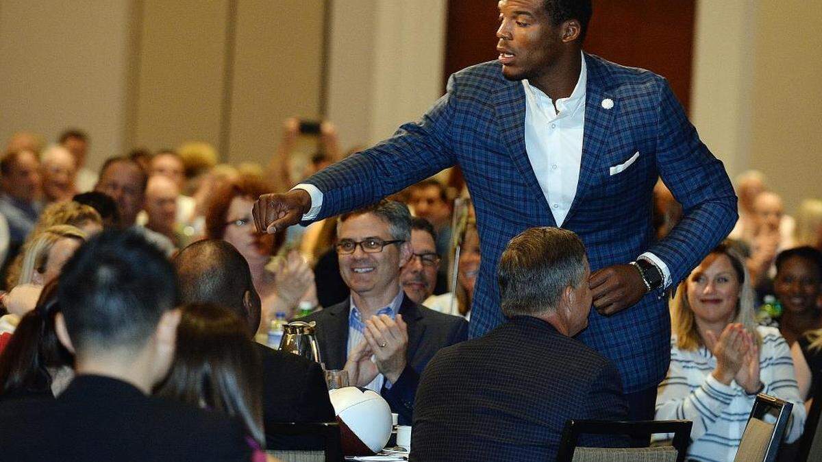 
Panthers quarterback Cam Newton gives everyone at his table a fist pound after his name was called to come on stage. The Charlotte Touchdown Club in sponsorship with Electrolux presented the 2015 Carolina Panthers Kickoff luncheon at the Westin hotel on Friday.
