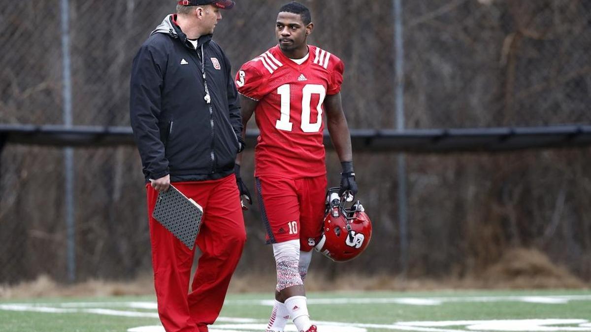 
N.C. State head coach Dave Doeren talks with running back Shadrach Thornton (10) after N.C. State football's first spring practice at the Dail football practice complex in Raleigh, March 3, 2015. 
