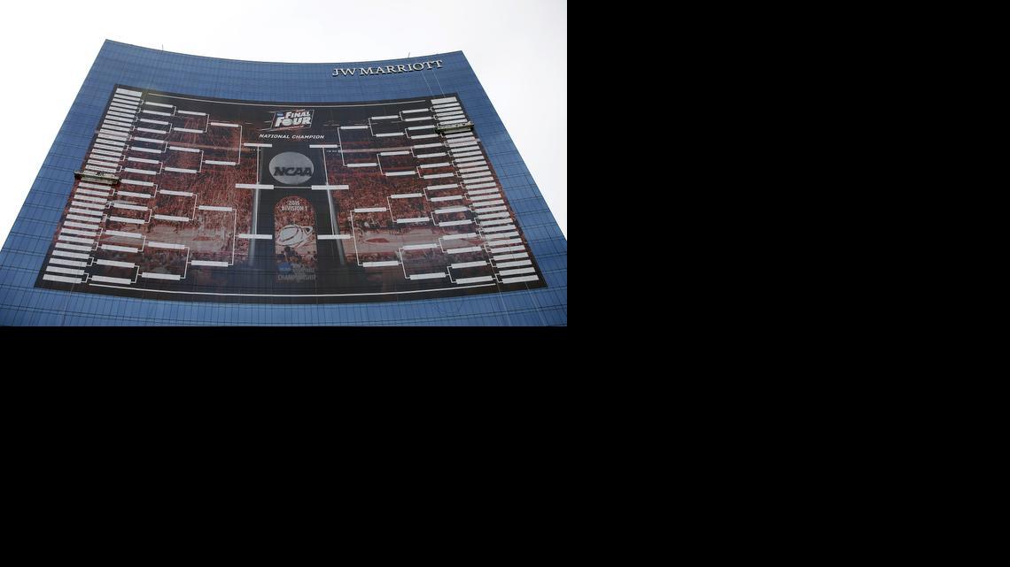 
Workers add team names to a 2015 NCAA Division I men’s basketball tournament bracket that is displayed on the side of the JW Marriott in Indianapolis on March 16. With the Final Four a week away from shining a spotlight on Indianapolis, NCAA President Mark Emmert said Thursday that the governing body for college sports is concerned about an Indiana law that could allow businesses to discriminate against gay people. 
