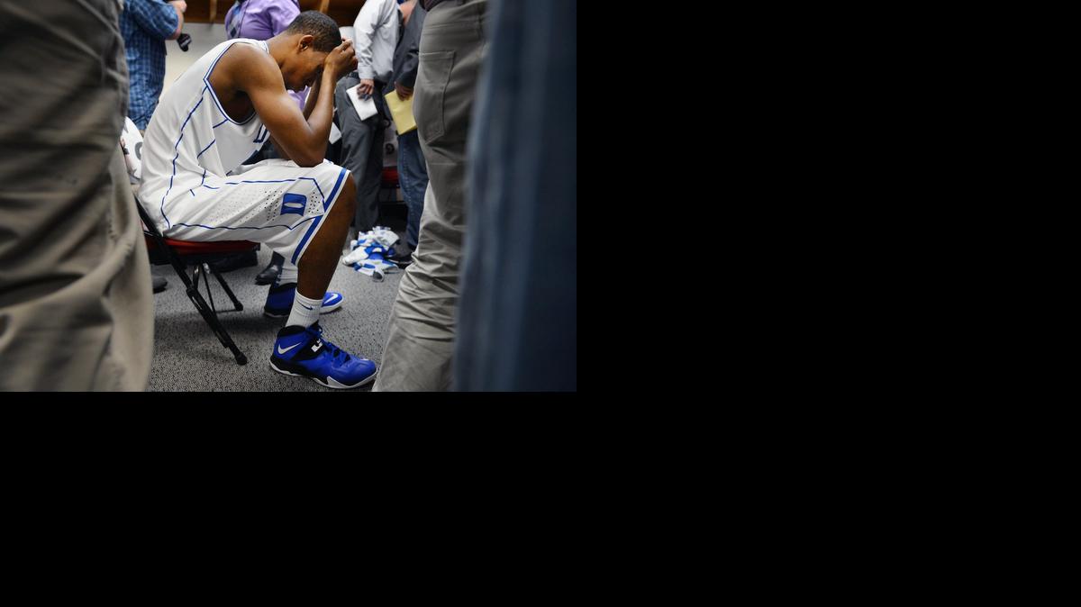 
Members of the media mill around Duke forward Rodney Hood (5) in the locker room after the Blue Devils were upset by Mercer 78-71 in their opening game of the NCAA Men's Basketball Tournament at the PNC Arena in Raleigh March 21, 2014.
