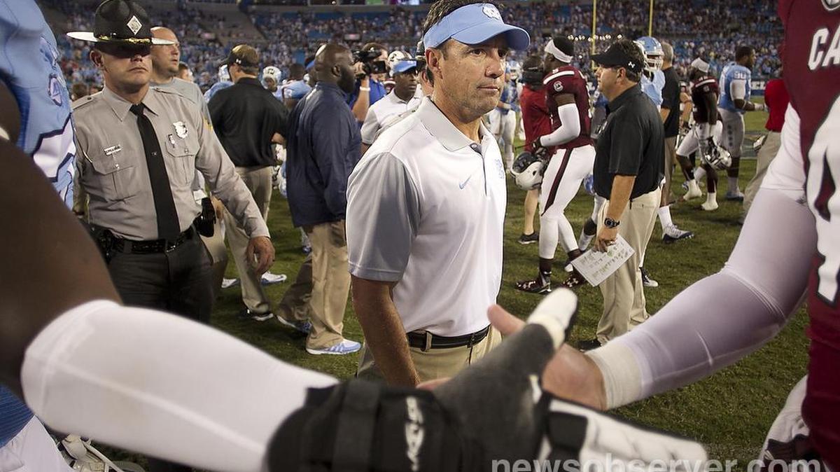 
North Carolina coach Larry Fedora leaves the field as players shake hands following the Tar Heels’ 17-13 loss to South Carolina in the Belk College Kickoff on Thursday at Bank of American Stadium in Charlotte.
