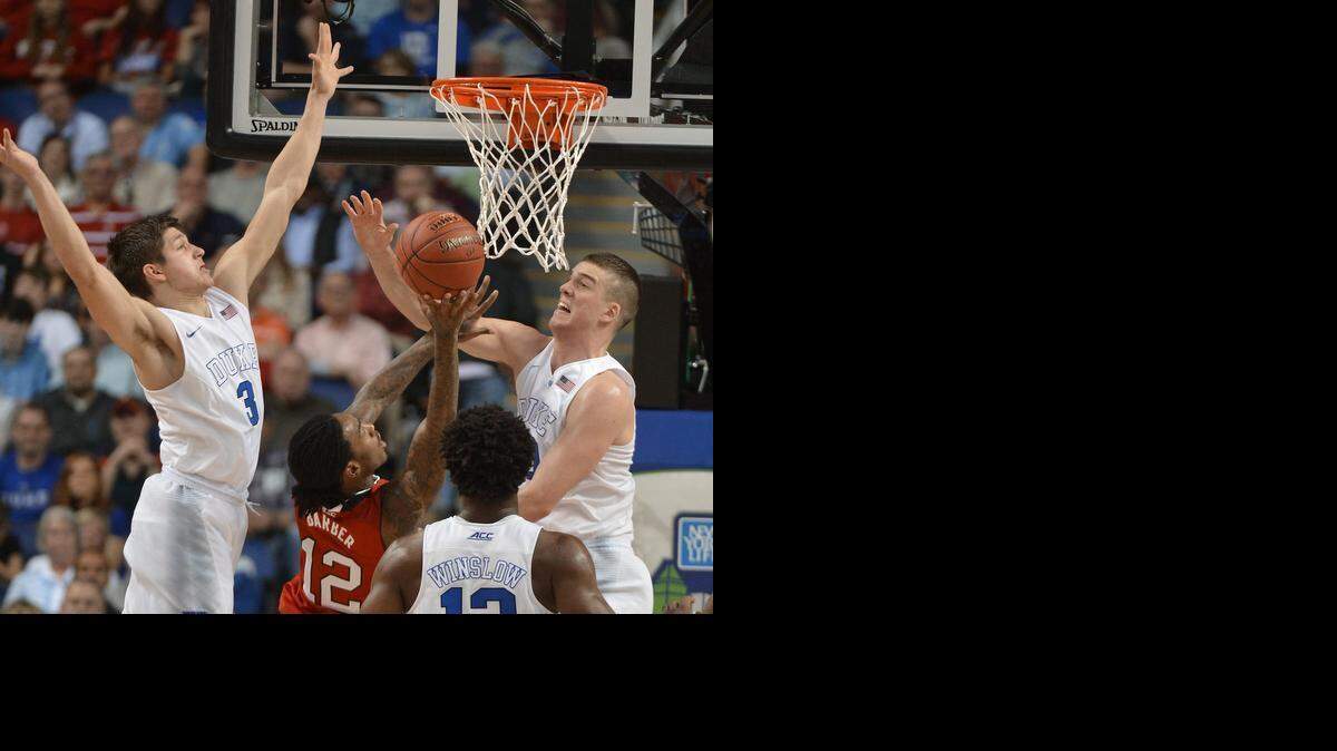 
Duke’s Grayson Allen (3) and Marshall Plumlee (40) block a shot by N.C. State’s Cat Barber (12) in the first half of play in the Atlantic Coast Conference basketball tournament at the Greensboro Coliseum.
