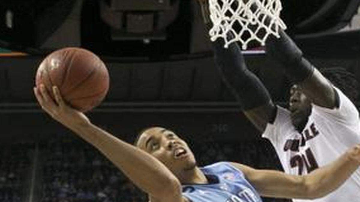 
North Carolina’s Brice Johnson (11) puts up a shot under Louisville’ Montrezl Harrell (24) during the quarterfinals of the ACC tournament at the Greensboro Coliseum.
