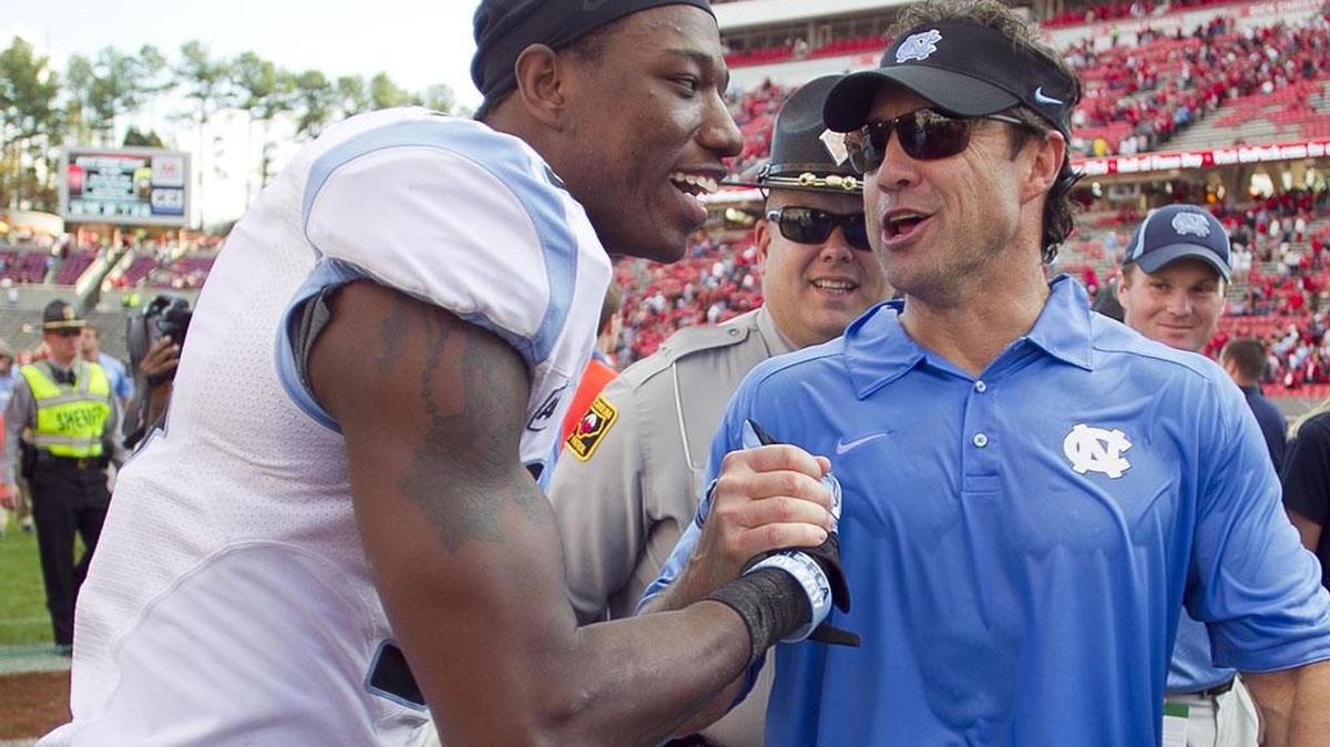 
UNC wide receiver Quinshad Davis and head coach Larry Fedora celebrate the Tar Heels' 27-19 victory over N.C. State in November 2013 at Carter Finley Stadium in Raleigh.
