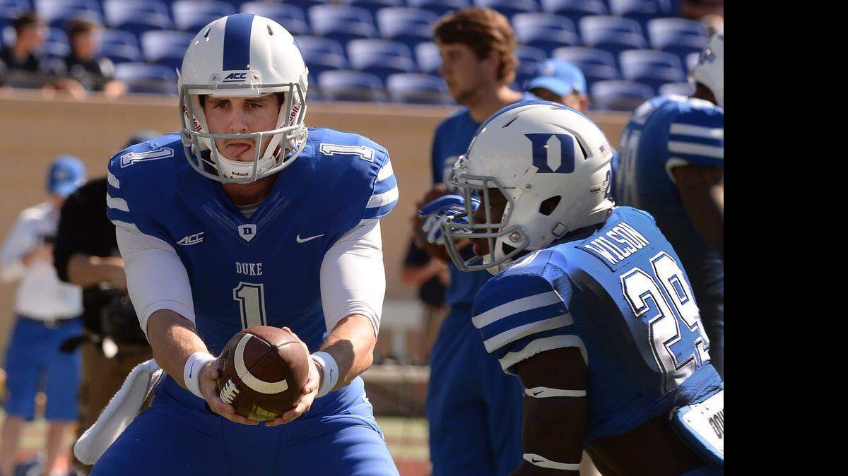 
Duke quarterback Thomas Sirk (1) hands off the ball to running back Shaun Wilson (29) during pre game warm-ups prior to their showdown with Virginia at Wallace Wade Stadium in Durham, NC Saturday, Sept. 18, 2014. 
